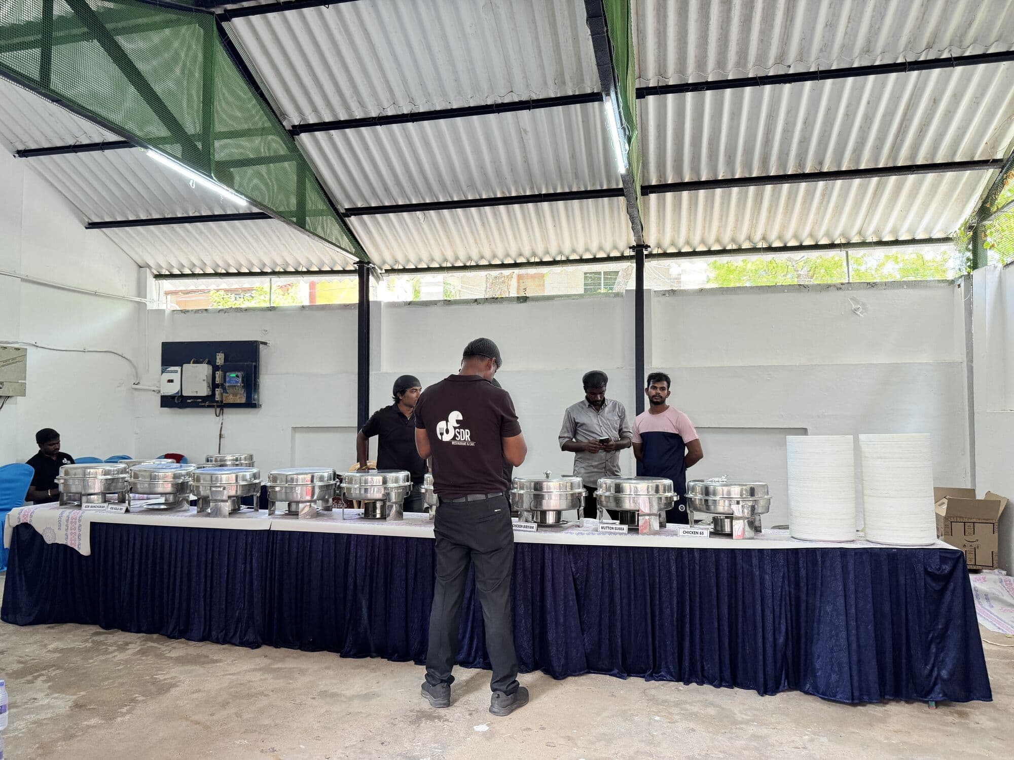 A long buffet counter of chafing dishes set up by the SDR team