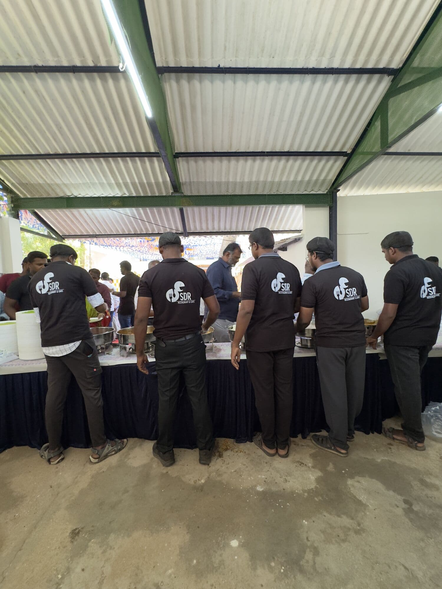 The SDR catering team lined up at the buffet counter